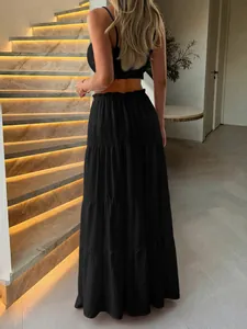 Elegant black two-piece women's holiday set with crop top and tiered ruffle maxi skirt