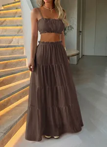 Detail of brown bohemian tiered maxi skirt and ruffle crop top set for women.