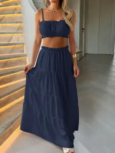 Elegant navy blue ruffled crop top and tiered maxi skirt two-piece vacation set.