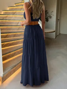 Back view of navy blue tiered maxi skirt and cropped tube top vacation two-piece set.