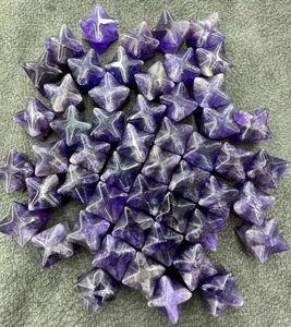 Detailed macro view of natural purple amethyst Merkaba star crystals in a bulk pile