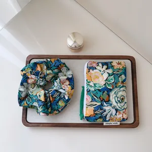 Oil painting style floral cotton scrunchie and matching small storage pouch set on tray