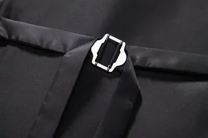 Detailed macro view showing the adjustable silver metal buckle on black men's vest