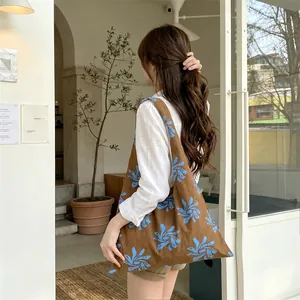 Stylish large capacity brown canvas tote bag featuring an elegant blue floral pattern