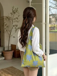 Artistic green canvas tote bag with blue floral print for daily commuting and shopping