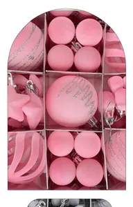 Close-up of pink flocked Christmas ornaments set in a compartmentalized gift box