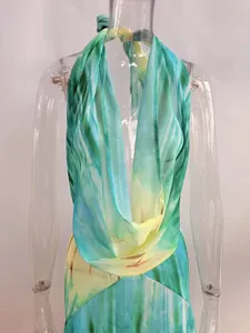 Detailed view of the deep V-neck and halter strap on a tropical tie-dye beach long dress