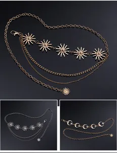 Detailed view of multi-layered gold and silver metal waist chains with sun pendants
