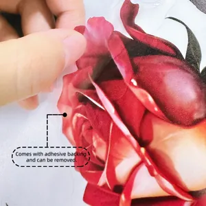 Close-up detail showing the removable adhesive backing of a red rose wall sticker
