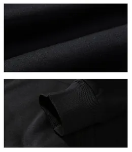 Detailed close-up of black men's autumn hoodie showing fabric texture and ribbed cuff
