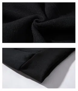 Macro view of high-quality black hoodie fabric texture and durable ribbed cuff stitching.