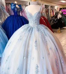 Detail of light blue Quinceañera ball gown with floral lace applique and puffy tulle skirt.