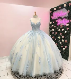 Detailed view of a luxury light blue tulle ball gown with floral lace and corset top