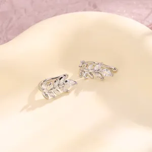 Elegant silver wheat ear cuffs with marquise-cut zircon leaves on a soft background.