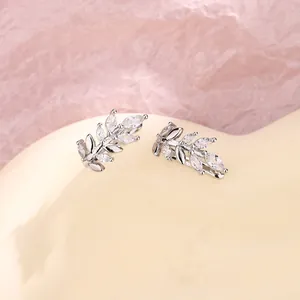 Detailed macro view of silver leaf ear cuffs with shimmering cubic zirconia inlay