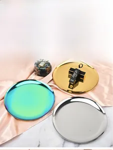 Close-up of Nordic style metal round trays in gold, silver, and rainbow colors