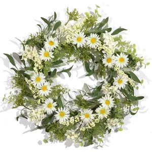 Detailed view of artificial daisy and greenery wreath for spring door decoration