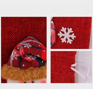 Detailed view of Christmas red burlap wine bottle bag with plush hat and drawstring