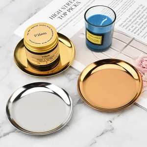 Close-up detail of Nordic metallic round storage trays in gold and silver finishes