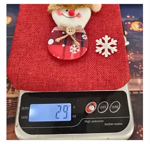 Detail of a Christmas burlap wine bottle cover showing a weight of 29g on a digital scale