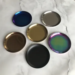 Six multi-colored Nordic minimalist stainless steel round trays on marble surface