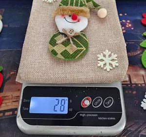 Detailed view showing the 28g weight of a Christmas burlap snowman wine bottle gift bag
