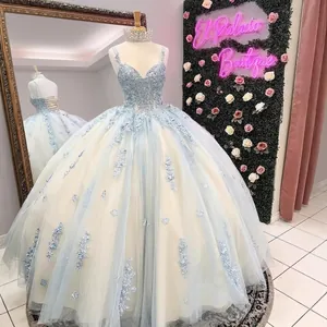 Elegant light blue ball gown featuring a beaded bodice and tiered tulle princess skirt.