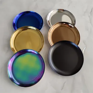 Detailed top view of six colorful Nordic circular metal trays on marble background