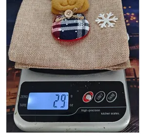 Detailed view of Christmas burlap wine bottle bag weighing 29 grams on a scale