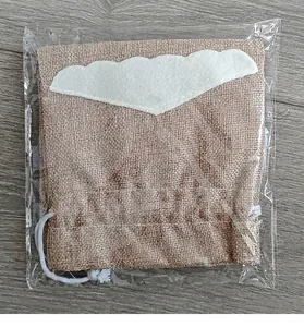 Decorative Christmas burlap wine bottle bag with felt beard detail in clear wrap