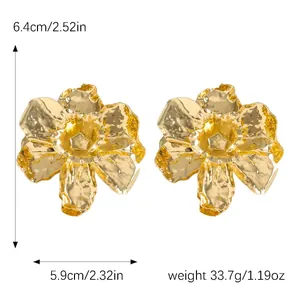 Macro detail of oversized hammered gold 3D flower earrings showing size and weight info