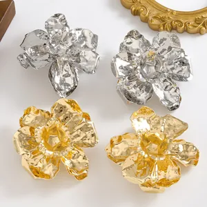 Statement 3D floral drop earrings with textured gold and silver metal finish.