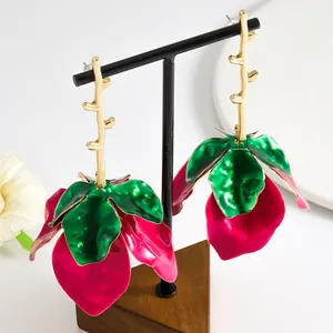 Detailed view of enamel flower drop earrings with golden stem and vibrant petals.