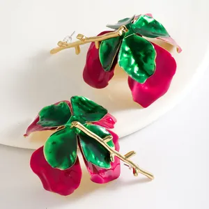 Vibrant 3D flower drop earrings with green leaves and gold stems in enamel finish