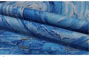Detailed macro view showing the artistic blue oil painting pattern on a soft fabric shawl