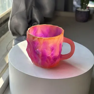 Macro detail view of faceted mineral crystal coffee mug with purple orange gradient finish