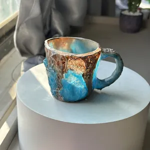Close-up of blue mineral crystal resin coffee mug with handcrafted rock texture