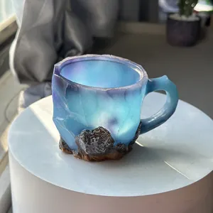 Detailed view of the blue translucent resin crystal coffee mug with rocky base texture.