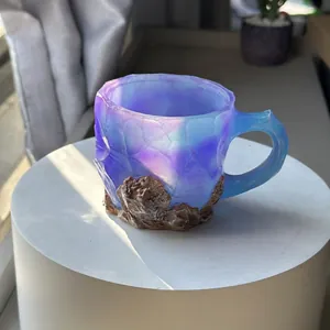 Close-up of translucent purple resin coffee mug featuring a realistic rock base