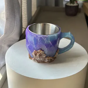 Macro view of mineral crystal resin mug showing rock texture and steel liner.