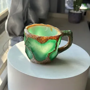 Macro detail of a green mineral crystal resin coffee mug with artisanal stone texture