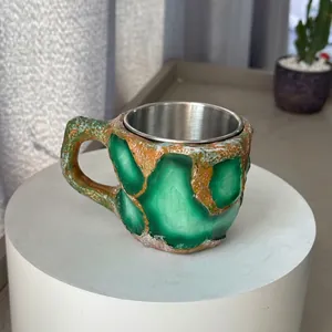 Macro view of unique mineral crystal resin coffee mug with stainless steel interior