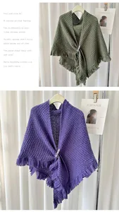 Detailed view of stylish purple and green knitted triangular shawls with fringe.