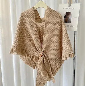 Elegant knitted triangular shawl with fringe and leather buckle in camel