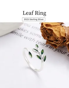 Detail of S925 sterling silver ring featuring green enamel leaf design on white background