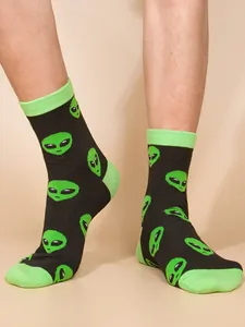 Stylish black crew socks featuring a vibrant lime green alien head pattern detail.