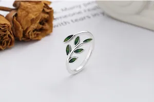 Macro detail of a 925 silver ring featuring delicate green enamel leaves