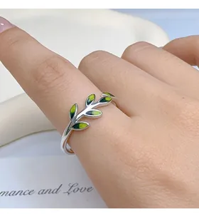 Close-up of a 925 sterling silver ring featuring a vibrant green leaf design.