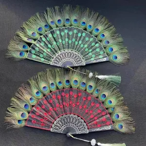Detailed view of two peacock feather folding fans with red and green embroidery