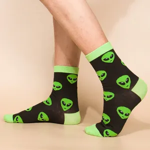 Stylish men's crew socks with neon green alien head pattern on a black background